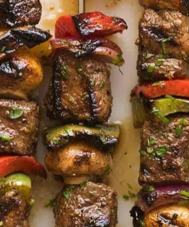 Forest Skewers Grilled meats and roasted vegetables glazed in a smoky herb sauce, served on carved wooden sticks.